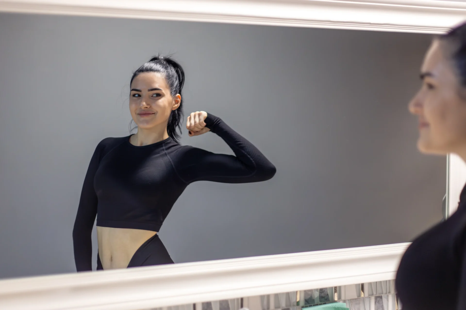 Woman with fresh post-facial glow in athletic wear at a day spa in Ferndale